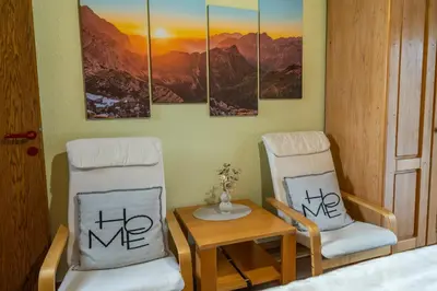 two chairs and a table in a room at Apartment Dijak in Bohinj