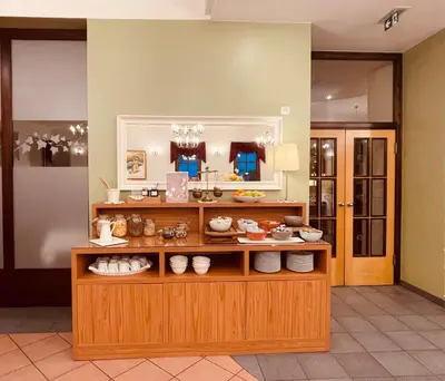 a display case with a bunch of food on it at Hotel Delalut in Ravne na Koroškem