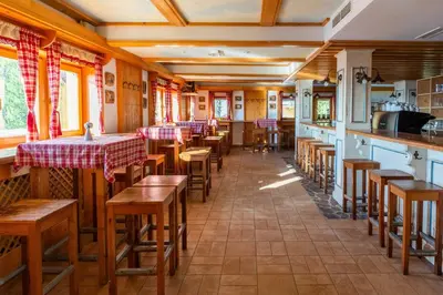 a restaurant with tables and chairs in a room at Hotel Krvavec in Cerklje na Gorenjskem