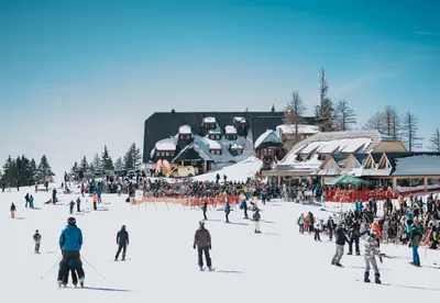 a large crowd of people on a ski resort at Hotel Krvavec in Cerklje na Gorenjskem