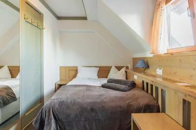 a bedroom with a bed and a window at Hotel Krvavec in Cerklje na Gorenjskem