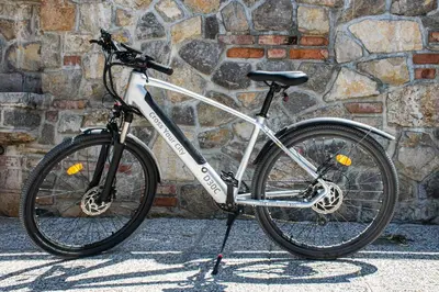 a bike parked in front of a stone wall at Youth Hostel Arsviva in Stari Trg pri Ložu