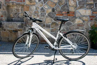 a bike parked in front of a stone wall at Youth Hostel Arsviva in Stari Trg pri Ložu