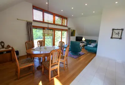 a dining room with a table and chairs at Villa Katarina in Mokronog
