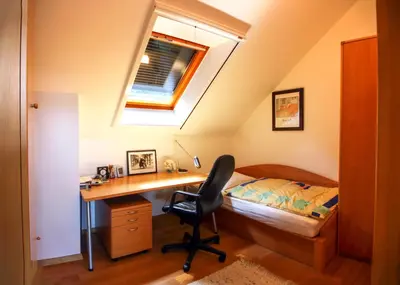 a bedroom with a desk and a bed and a desk chair at Villa Katarina in Mokronog
