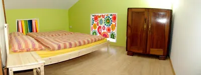 a bedroom with a bed and a wooden cabinet at Soča House Tolmin in Tolmin