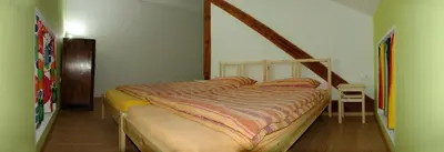 a bedroom with a bed with a striped comforter at Soča House Tolmin in Tolmin