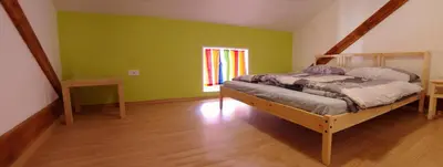 a bedroom with a bed in a room with green walls at Soča House Tolmin in Tolmin