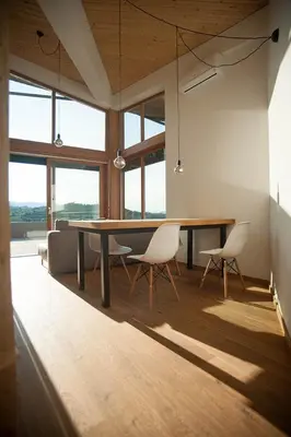a dining room with a table and chairs at Apartment Oton Reya in Dobrovo