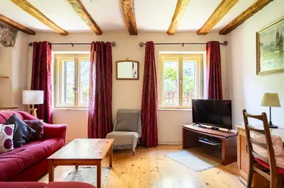 a living room with a red couch and a tv at Holiday Home Katric in Kamno