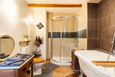 a bathroom with a tub and a shower and a toilet at Holiday Home Katric in Kamno