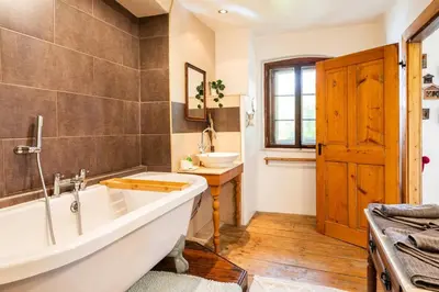 a bathroom with a large tub and a sink at Holiday Home Katric in Kamno