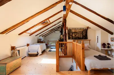 a attic bedroom with two beds and a staircase at Holiday Home Katric in Kamno