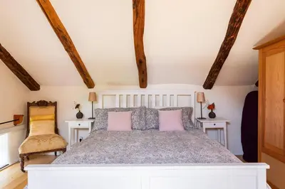 a bedroom with a large white bed with pink pillows at Holiday Home Katric in Kamno