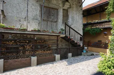 a house with a staircase and a building with flowers at Holiday Home Katric in Kamno
