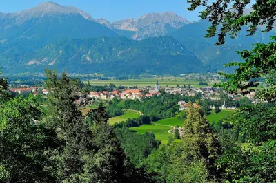 a town in a valley with mountains in the background at B&B Woodhouse in Brezje