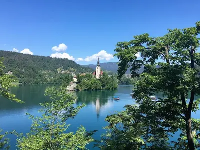 a view of a lake with a castle in the middle at B&B Woodhouse in Brezje