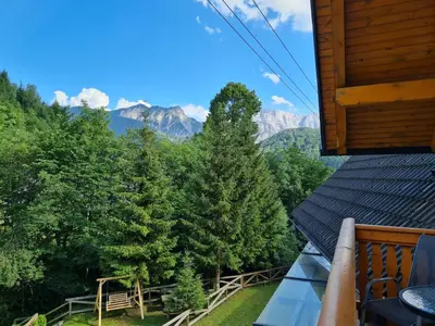 a balcony with a view of trees and mountains at Apartments Karmen in Rateče
