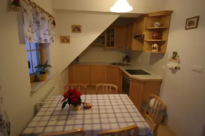 a small kitchen with a table and chairs in it at Apartments Karmen in Rateče
