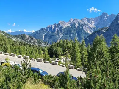 a parking lot with mountains in the background at Apartments Karmen in Rateče