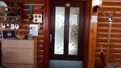 a wooden door with a window in a room at Tourist Farm Znidarjevi in Kožljek