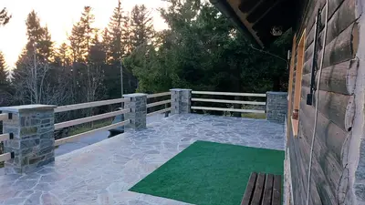 a deck with a green mat on a fence at Rogla - Chalet Mojca Pokrajculja in Zreče