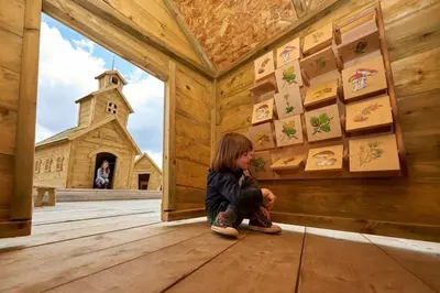 a little child sitting in a room with a church at Rogla - Chalet Mojca Pokrajculja in Zreče