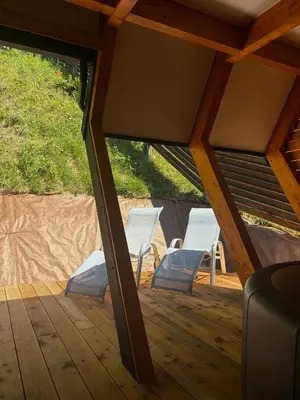 two white chairs sitting on a wooden deck at Apartments Beeland Skok in Mozirje
