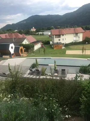 a view of a house and a swimming pool at Apartments Beeland Skok in Mozirje
