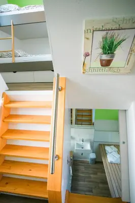a room with two bunk beds and a staircase at Apartments Beeland Skok in Mozirje