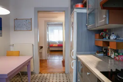 a kitchen with a counter top and a room at Tomas's apartment in Ljubljana