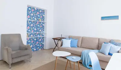 a living room with a couch and a chair at Taya apartment in Ljubljana