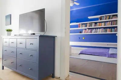 a bedroom with a dresser with a tv on it at Taya apartment in Ljubljana