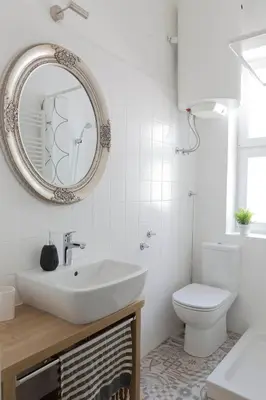 a bathroom with a sink and a toilet and a mirror at Taya apartment in Ljubljana
