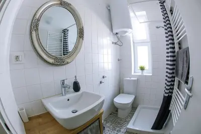 a bathroom with a sink and a toilet and a mirror at Taya apartment in Ljubljana