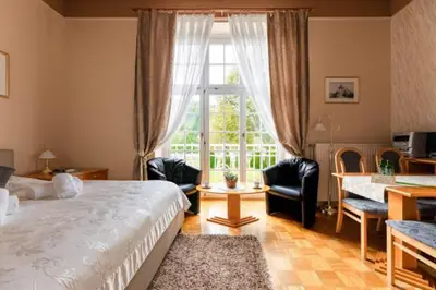 a bedroom with a bed and a desk and a window at Apartment Vila Golf in Rogaška Slatina