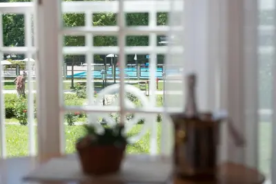 a window with a view of a table and chairs at Apartment Vila Golf in Rogaška Slatina