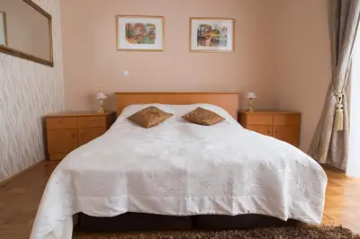 a white bed with two pillows on top of it at Apartment Vila Golf in Rogaška Slatina