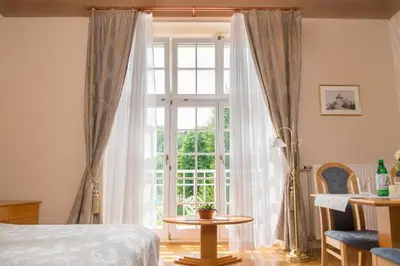 a bedroom with a bed and a large window at Apartment Vila Golf in Rogaška Slatina