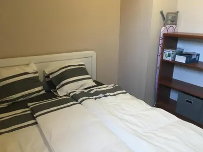a bed with black and white striped pillows on it at Old part Apartments Banjac in Maribor