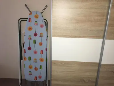 a suitcase with flowers on it next to a wall at Old part Apartments Banjac in Maribor