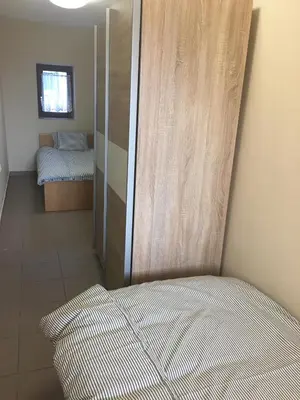 a small bedroom with a bed and a closet at Old part Apartments Banjac in Maribor