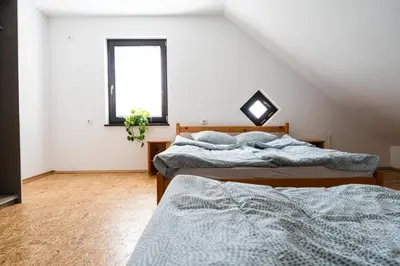 two beds in a room with a window at Adventure Farm in Štore