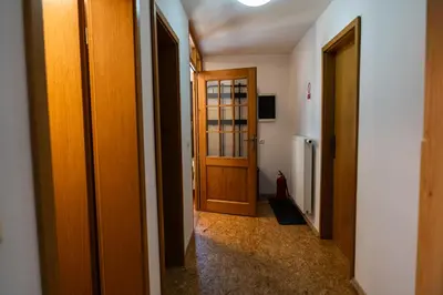 a hallway with wooden doors in a room at Adventure Farm in Štore