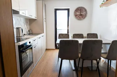 a kitchen with a table and chairs in a room at Adventure Farm in Štore