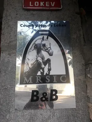 a sign with a picture of a horse on the ground at Country House Lokev in Lokev