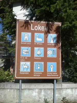a brown sign with symbols on it at Country House Lokev in Lokev