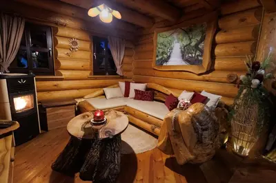 a living room with a couch in a log cabin at Village Cottage - Koča na vasi in Nazarje