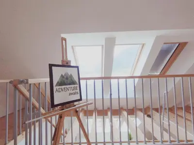 a sign on a rail in a room with a staircase at Apartments Wallas in Bovec