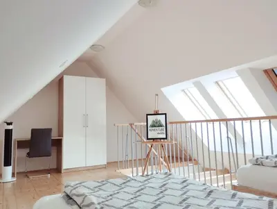 a bedroom with a bed and a desk in a attic at Apartments Wallas in Bovec